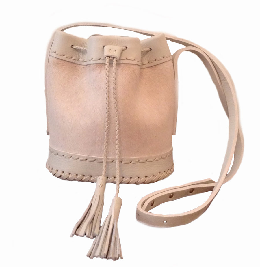 Summer Blush light Pink Cream Off White Leather cowhide Pony Cow Fur Small carriage Bag Wendy Nichol Luxury Handbag purse Designer handmade in NYC New York City bucket Drawstring Draw String Pouch Small fringe tassel Mini cross body adjustable durable strap High Quality Leather