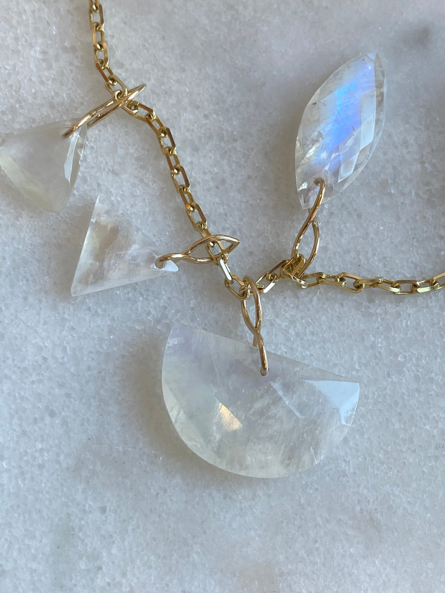 Faceted Half Moon Moonstone on a 14k yellow gold infinity bale