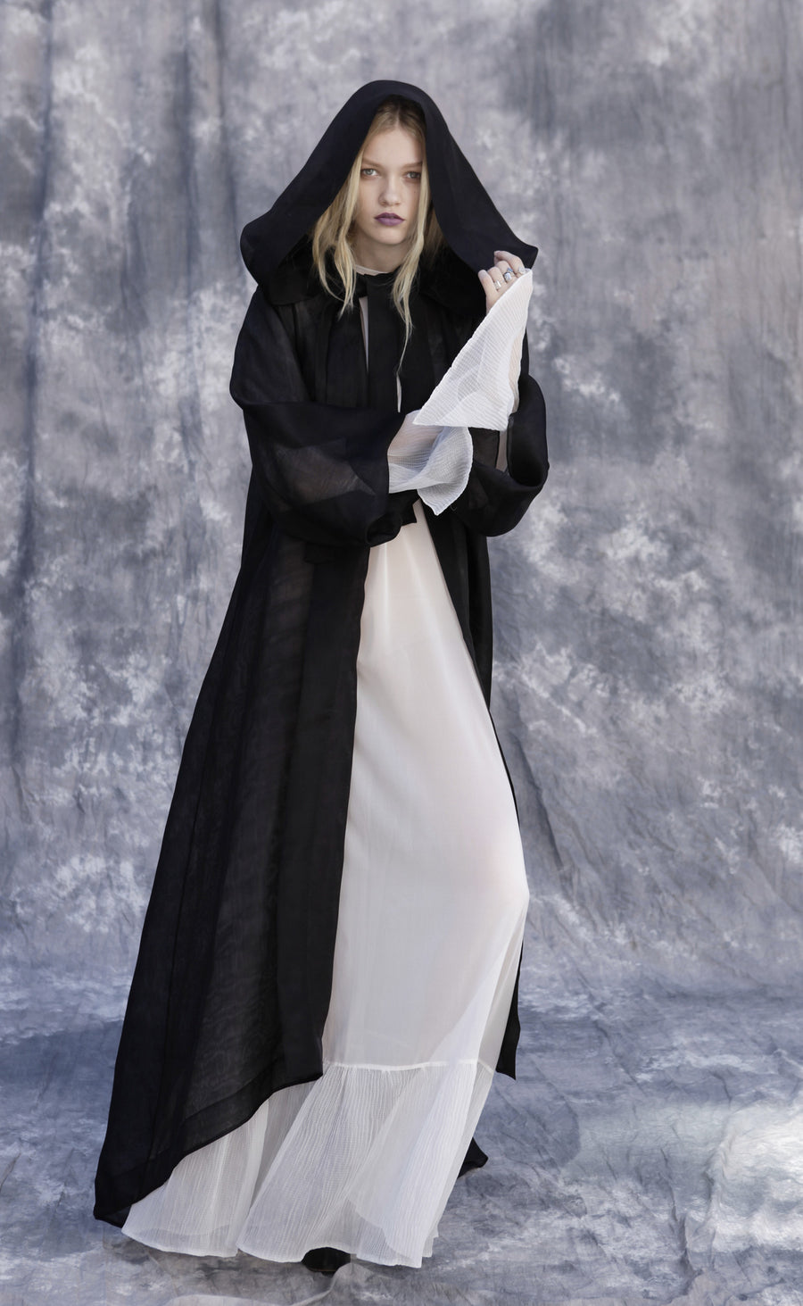 Maggie Laine IMG model Wendy Nichol New York Clothing Designer Handmade in NYC New York City SS17 Fashion Runway Show Signals to the Mothership Made to Order Custom Tailoring Made to Measure Death Valley Black Sheer Hood Hooded Cape Cloak Coat Belle Sleeves Long Train Oversized Hood White Sheer Apron Cross Tie Pleated Sleeves Dress Victorian Edwardian Gothic Goth Pagan Witch High Priestess Sorceress Magician Wizard 