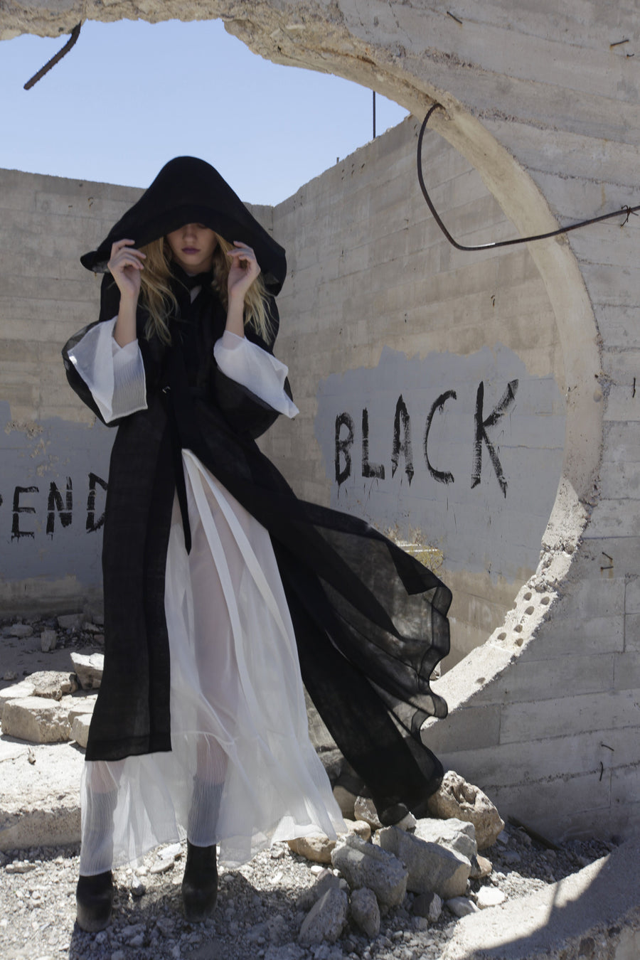 Maggie Laine IMG model Wendy Nichol New York Clothing Designer Handmade in NYC New York City SS17 Fashion Runway Show Signals to the Mothership Made to Order Custom Tailoring Made to Measure Death Valley Black Sheer Hood Hooded Cape Cloak Coat Belle Sleeves Long Train Oversized Hood White Sheer Apron Cross Tie Pleated Sleeves Dress Victorian Edwardian Gothic Goth Pagan Witch High Priestess Sorceress Magician Wizard 
