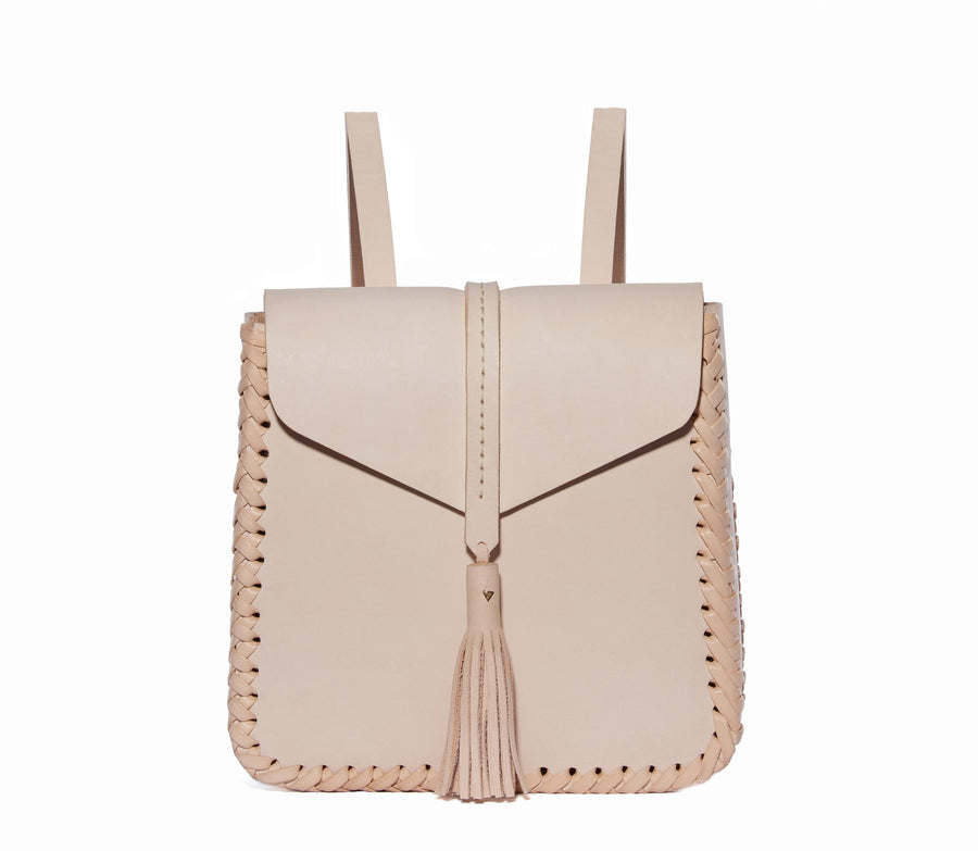 Natural Pink Tan Eco Leather Saddle Envelope Closure Flap Small Tiny Mini Backpack Wendy Nichol Designer Handbag Bag Purse Handmade in NYC New York City Adjustable Strap Fringe Tassel Tassels Structured Structure Square Braided edges interior pocket durable Cher Clueless
