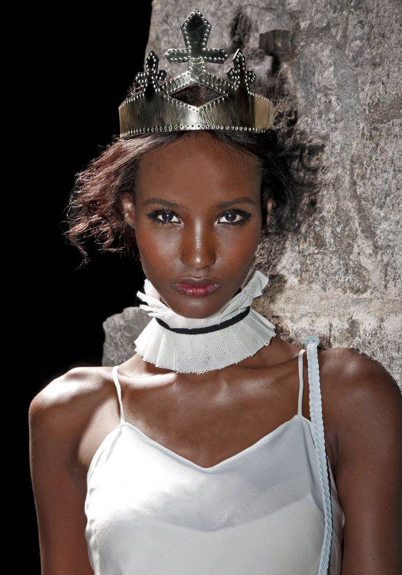 Fatima Siad IMG Model Wendy Nichol Clothing Designer Ready to Wear Fashion Runway Show SS14 Saints of the Zodiac Astrological Sign Leo the Lion White Bias Cut Long Train White Net Tulle Inserts Panels Cut Out strap Cotton Silk White Ruffle Edwardian Collar with Black Ribbon Gold Black Patent Leather Queen Crown Handmade in NYC New York City made to Measure Order Custom Tailoring Fabric Color