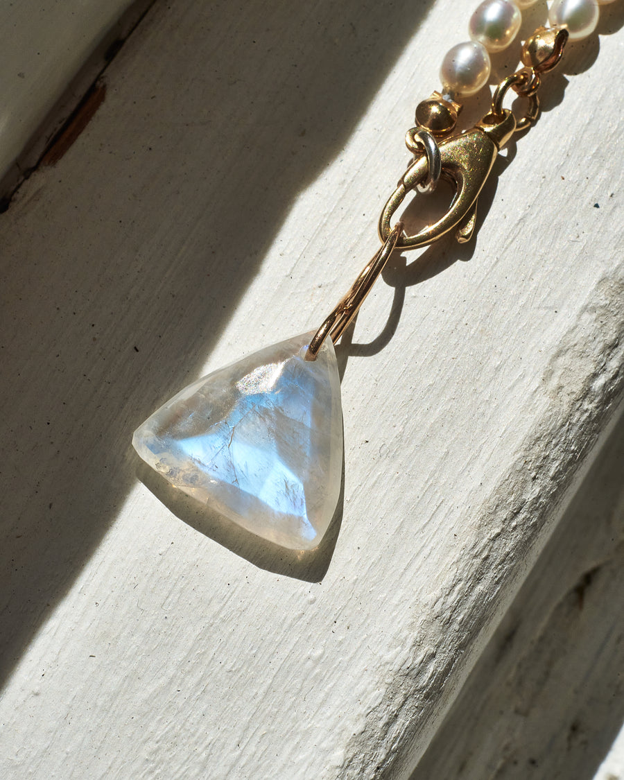 Faceted Trillion Moonstone on a 14k yellow gold infinity bale